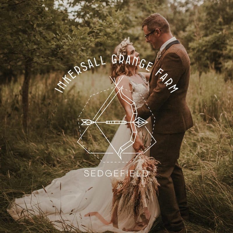 Wonderland Wedding Venues | A bride and groom stand close in a grassy field surrounded by trees at the exclusive wedding venue, Mkersall Grange Farm, Sedgefield. Gazing into each other's eyes, the bride holds a bouquet of dried flowers. Their serene, happy expressions complete this idyllic Nottinghamshire scene.