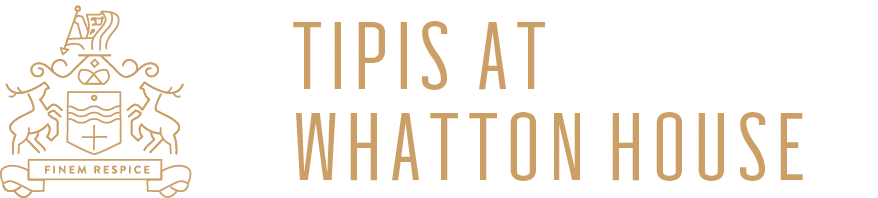 Wonderland Wedding Venues | A logo featuring a gold crest with two deer, a shield adorned with waves and a cross, and the motto "Finem Respice" above the text "Tipis at Whatton House" in gold on a dark green background.